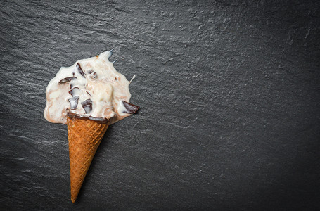 冰淇淋香草和巧克力滴在黑暗背景下图片