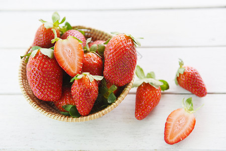 木制背景成熟的红草莓篮子采摘图片