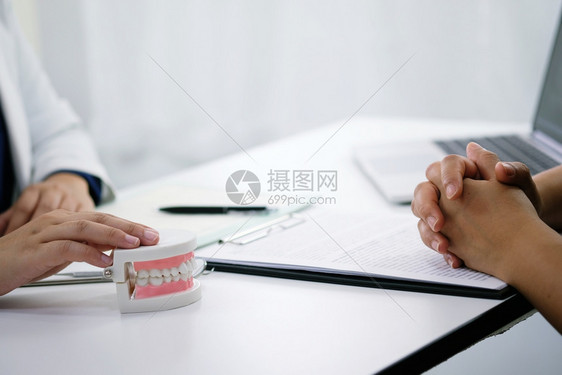 牙医在科办公室检查病人牙齿治疗图片