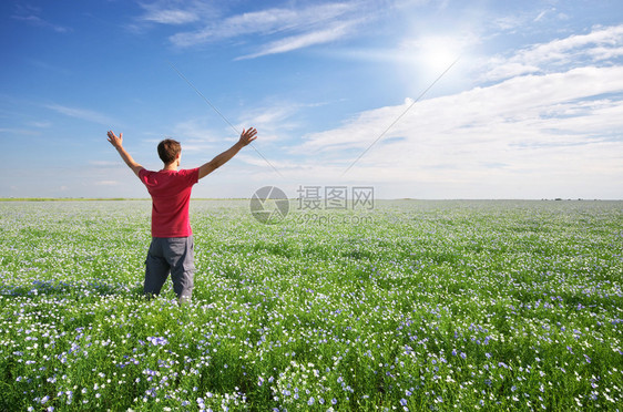 开满小花的草原上一个男人张开双臂图片