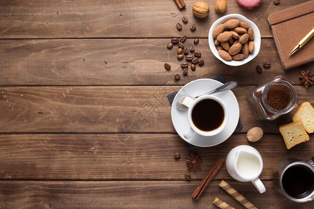 木制背景表格上方的咖啡和豆子图片