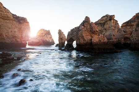 美丽的大西洋景色沙滩岩石和日出时的海浪图片