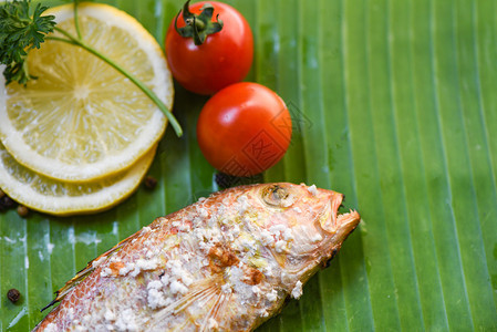 海食烤鱼含盐品和香蕉叶底柠檬柑橘番茄图片