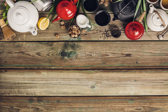 各种茶叶和壶的成分干草药绿茶黑和木制桌底平铺复制空间绿色黑茶和木制桌底的红茶图片