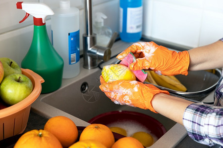 在厨房里用水肥皂或洗涤剂清水果图片