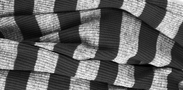 黑色和白条纹温暖毛衣编织的布水平背景图片