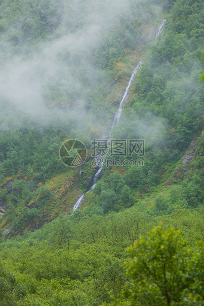 山上瀑布雾雨日美丽的绿色夏季风景旅行和游山地雾日挪威的瀑布图片