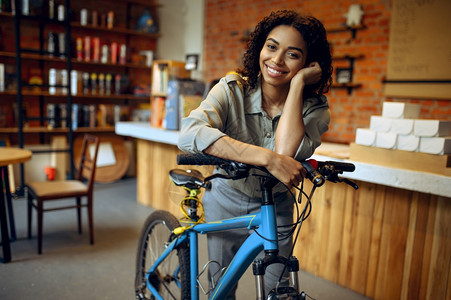 女学生在咖啡馆的自行车上微笑女学生在校园餐厅的休息女学生在咖啡馆的自行车上微笑图片