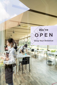 为具有亚洲服务员和女背景的新普通餐厅重开放带有社会距离的餐厅标志在开业前准备餐厅图片