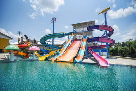 游乐园带泳池的水公园幻灯片户外水公园带游泳池的彩色塑料水幻灯片背景图片