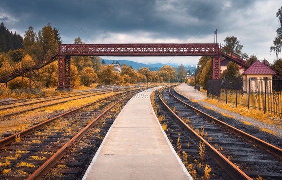 秋天的农村火车站阴云多旧铁路平台橙树桥梁建筑云天的工业景观农村的铁路和美丽森林秋季铁路图片