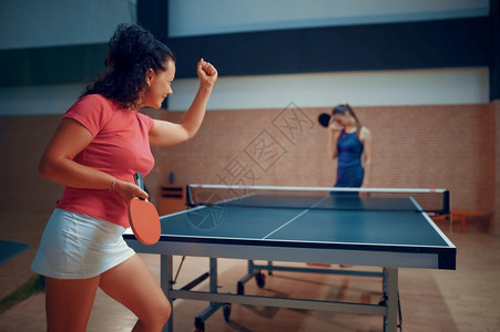妇女打乒乓球网在室内桌玩游戏积极健康生活方式打乒乓球桌图片