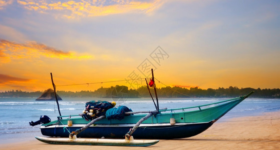 美丽的海景和日落天空与海洋传统木制渔船斯里兰卡图片