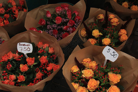 在市场上配有各种颜色的玫瑰和浆果布束关于标签的文字以欧元制作的花束价格荷兰文背景图片