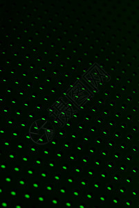 黑色塑料网状纹理绿光反背景图片