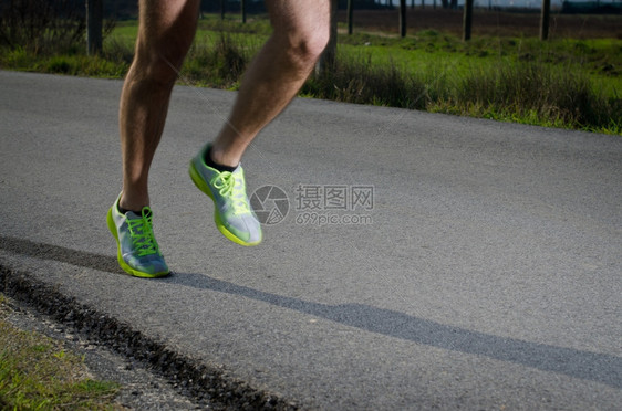 在乡间公路上运动鞋在户外男鞋在年轻人的训练中运动模糊重心放在后跑鞋上图片