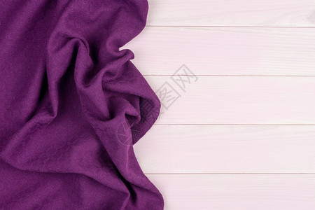 在木制厨房桌子上方有紫色毛巾从上面看图片