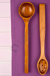 餐具在木制桌的紫毛巾上从面看图片