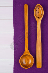 餐具在木制桌的紫毛巾上从面看图片
