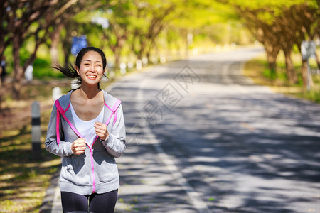 在公园中奔跑的健身妇女图片