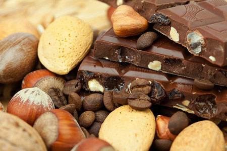 巧克力和坚果在树皮垫上图片