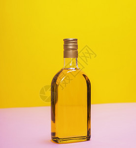 黄色背景上液体的玻璃瓶图片