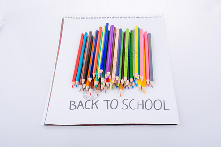 彩色铅笔和返回记本上的学校职称图片