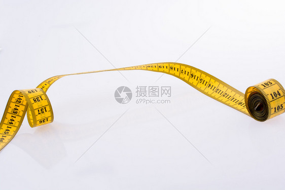 黄色测量磁带白背景的黄测量磁带图片