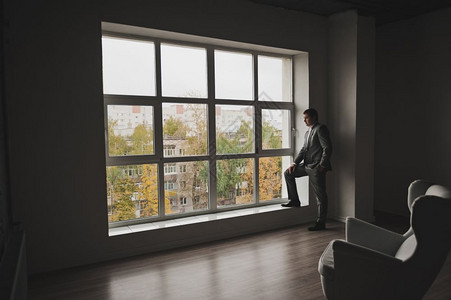 站在大窗户143旁边的一个人肖像背景图片