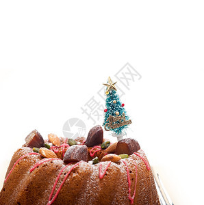 圣诞蛋糕甜圈树作为节日装饰品在白色背景的顶端图片