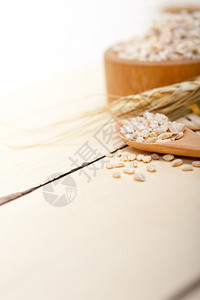 生木材桌上的有机大麦颗粒图片