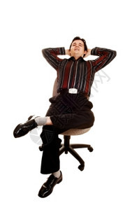 一名商人坐在办公室的椅子上穿着衣服的裤子并用他手在头部后面脱衣服以换取白背景图片