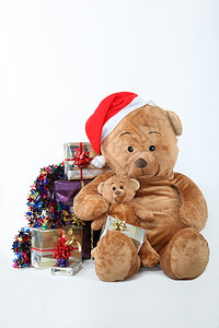 被圣诞礼物包围的泰迪熊图片