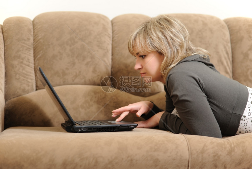 在家里用笔记本电脑工作的女人房子条件沙发图片