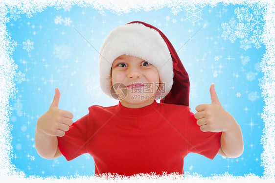 穿着红圣诞老人帽子的快乐男孩图片