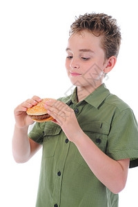 小男孩在吃汉堡包孤立在白色背景上图片
