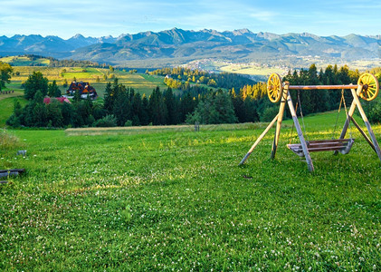 夏季上午Hazy山村风景和前面摇摆后的Tatra山脉波兰GliczarowGorny图片