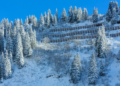 冬山坡上有雪壁和金属的屏障图片