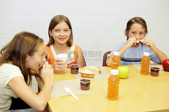 一群在校儿童学食堂吃午饭图片