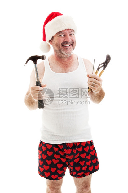 父亲带着圣诞老人的帽子微笑着拿工具他准备送圣诞礼物图片
