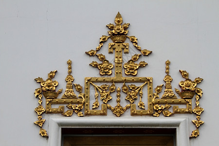在泰国曼谷寺庙门下墙壁上的金装饰图片
