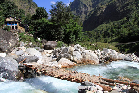 尼泊尔村庄的Wooden桥和河流图片