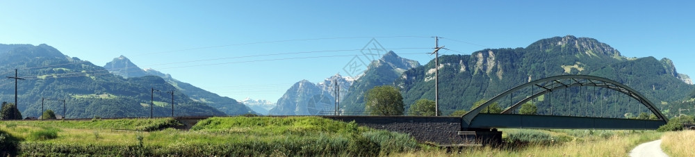 瑞士铁路桥梁和绿田全景图片