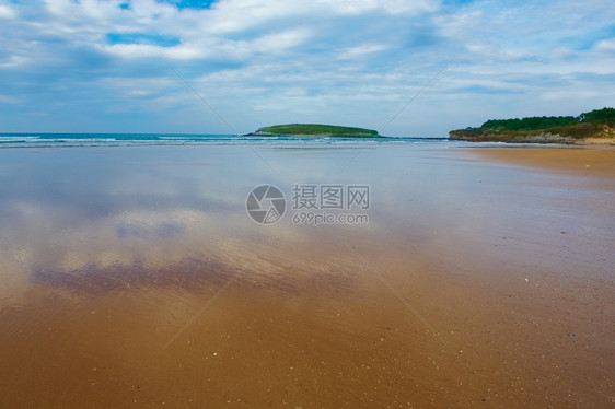 在西班牙大洋海岸的潮汐浪中反射的云图片