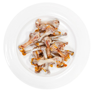 剩菜剩饭白背景鸡骨头在盘子上摘到的鸡骨头背景