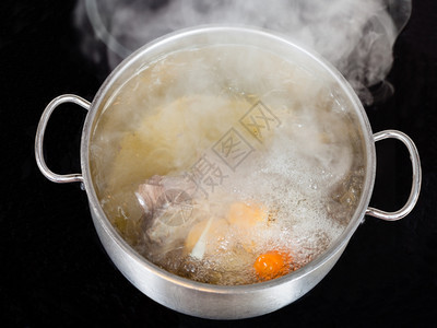 在玻璃陶瓷锅炉上煮牛肉汤的蒸气图片