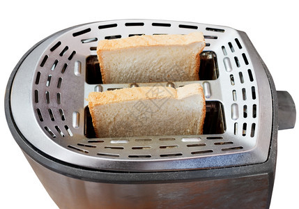 在白色背景上隔离的金属烤面包机中的两片新鲜面包图片