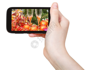 手持机在白色背景上隔绝的屏幕保持圣诞节的死活图片