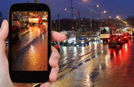 旅行概念旅游照片智能手机在雨中的街道上夜间汽车交通照片图片