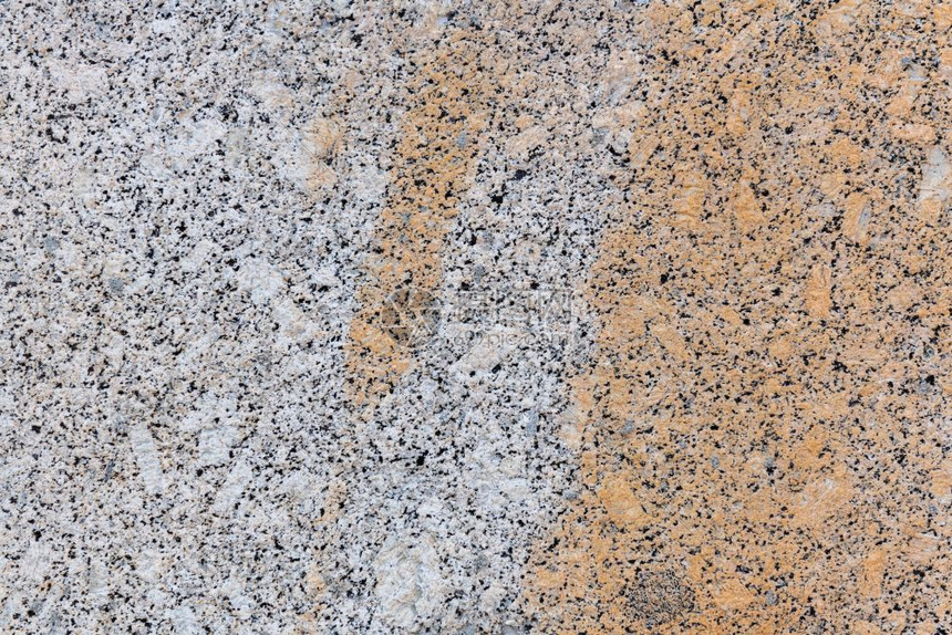 灰色花岗岩平滑光的石质磨统一表面含深层的灰色石头装饰材料背景纹理